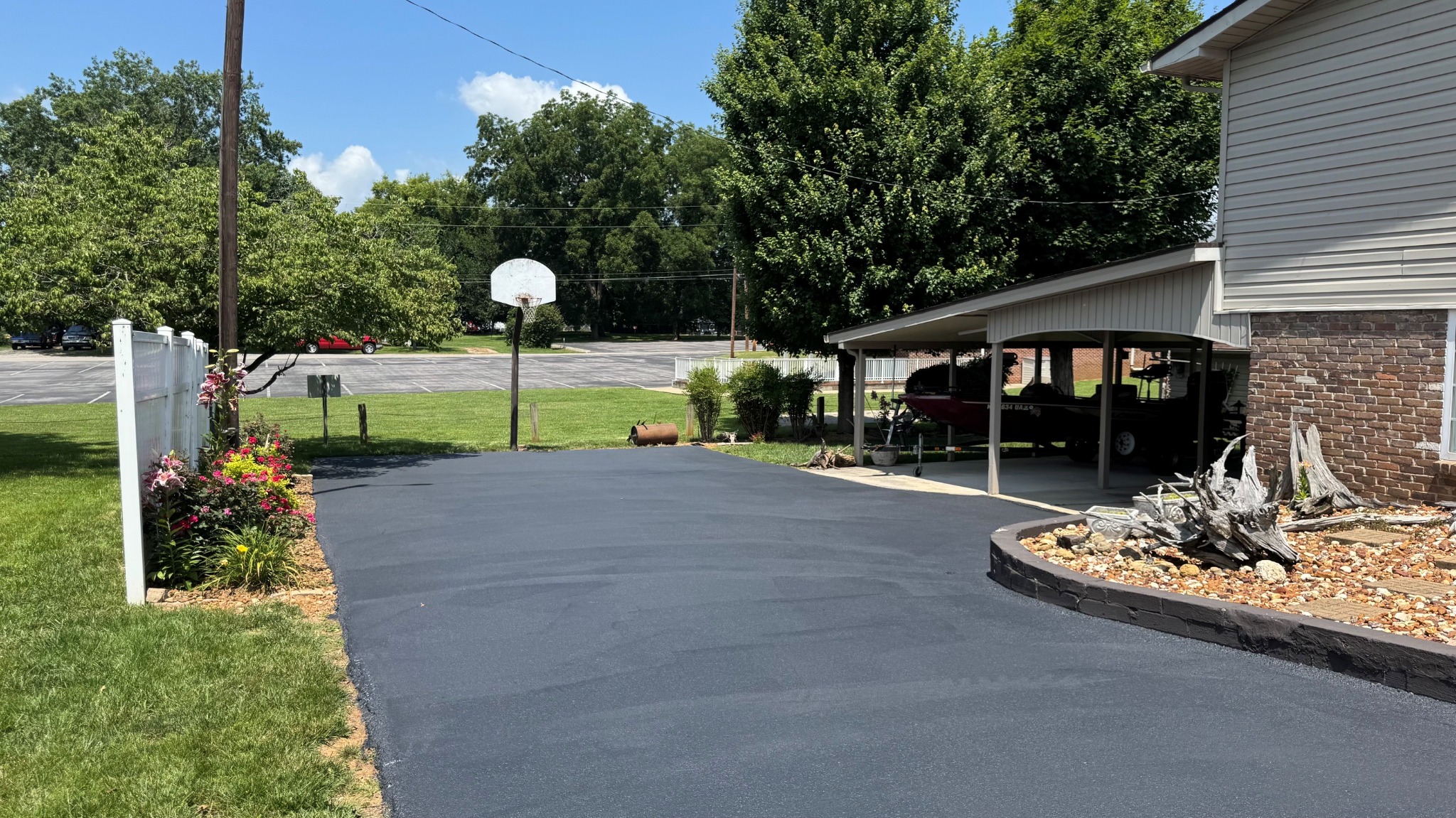 Freshly sealcoated residential driveway completed by Highline Pavement Maintenance